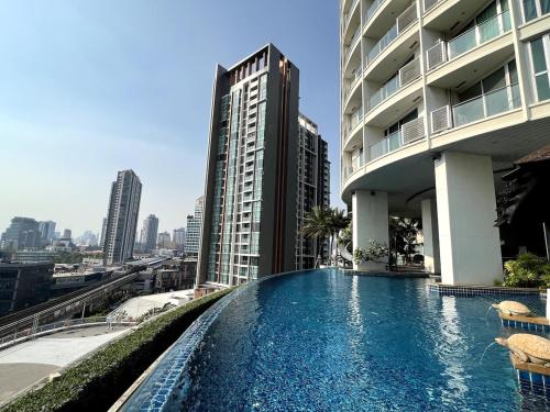 a swimming pool on the side of a building at Sky Residence in Ekkamai in Bangkok