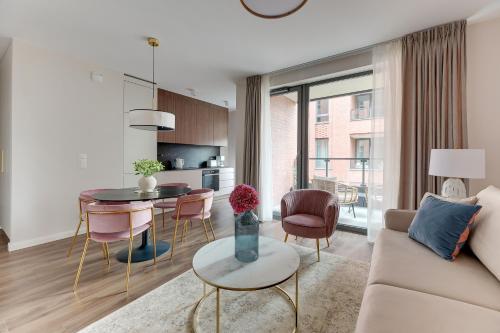 a living room with a couch and a table at Scala City Center Magic Apartments with Parking by Lion Apartments in Gdańsk