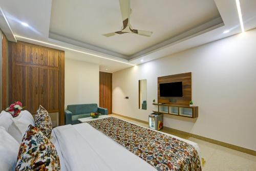 a hotel room with a bed and a tv at Hotel Dream World - Free Airport Drop in New Delhi
