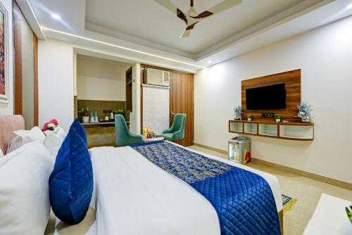 a hotel room with a bed and a tv at Hotel Dream World - Free Airport Drop in New Delhi