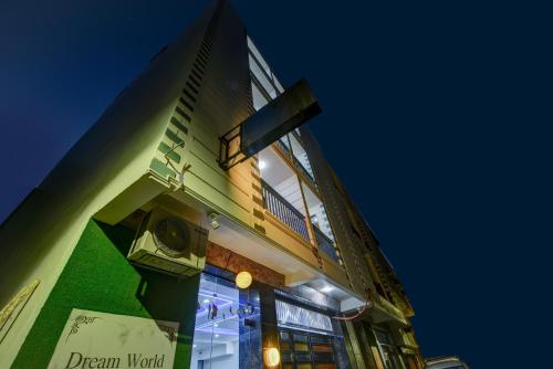 a tall building with a clock on the side of it at Hotel Dream World - Free Airport Drop in New Delhi
