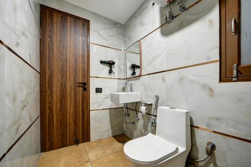a bathroom with a toilet and a sink at Hotel Dream World - Free Airport Drop in New Delhi