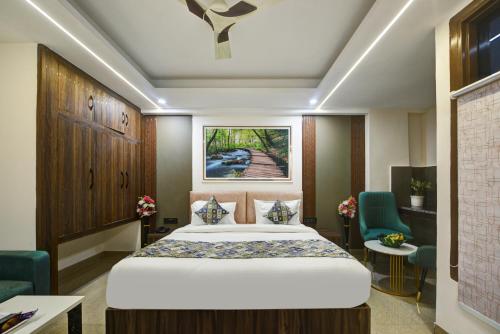 a hotel room with a bed and two chairs at Hotel Dream World - Free Airport Drop in New Delhi