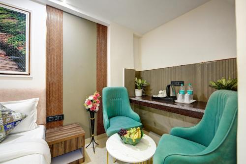a hotel room with two green chairs and a counter at Hotel Dream World - Free Airport Drop in New Delhi