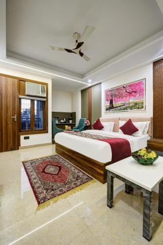 a bedroom with a large bed and a living room at Hotel Dream World - Free Airport Drop in New Delhi