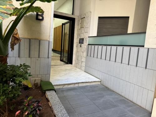a walkway leading to a building with a door at Studio Appartement MIRAMAR in Mohammedia