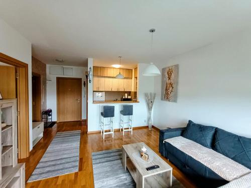 a living room with a couch and a table at MV Dreams, free parking in Novi Sad