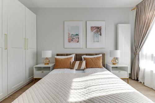 a bedroom with a large bed with two night stands at Scala City Center Magic Apartments with Parking by Lion Apartments in Gdańsk