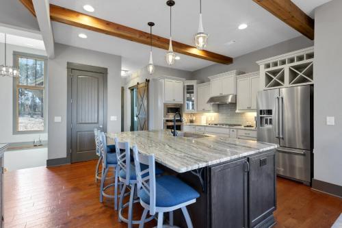 a kitchen with a large island with blue bar stools at Lakefront Getaway Dock Fire Pit & Games in Seneca