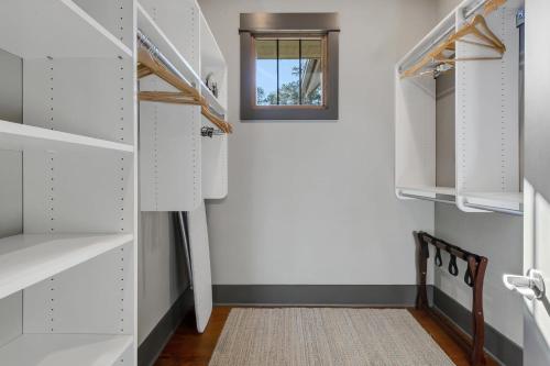 a walk in closet with white cabinets and a window at Lakefront Getaway Dock Fire Pit & Games in Seneca