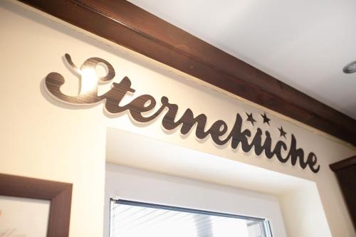 a sign above a door with the word at Ferienhaus Martje in Hennstedt