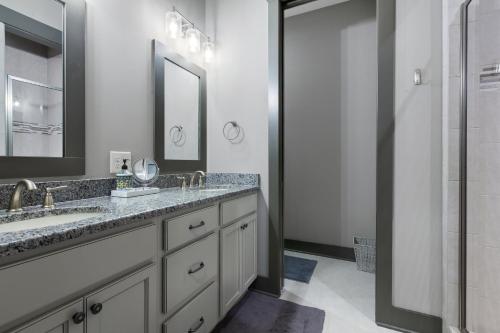 a bathroom with a double sink and a shower at Lakefront Getaway Dock Fire Pit & Games in Seneca