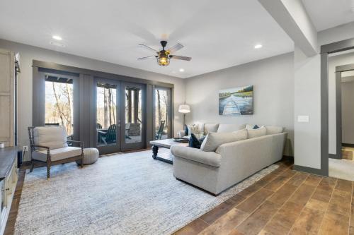 a living room with a couch and a ceiling fan at Lakefront Getaway Dock Fire Pit & Games in Seneca