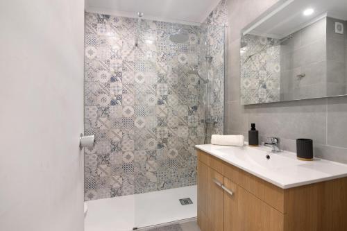 a bathroom with a shower with a sink and a tub at Lovely And New Apartment In Oura in Albufeira