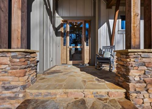 an entrance to a house with a stone wall at Lakefront Getaway Dock Fire Pit & Games in Seneca