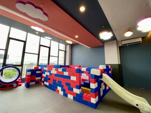 a play room with a lego couch and a slide at K AVENUE B17 house room near airport by Gc in Kota Kinabalu