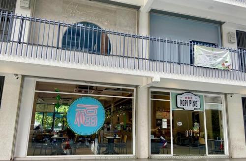 a restaurant with a balcony on the side of a building at K AVENUE B17 house room near airport by Gc in Kota Kinabalu