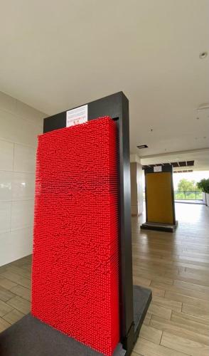 a large red wall in a room with a floor at K AVENUE B17 house room near airport by Gc in Kota Kinabalu