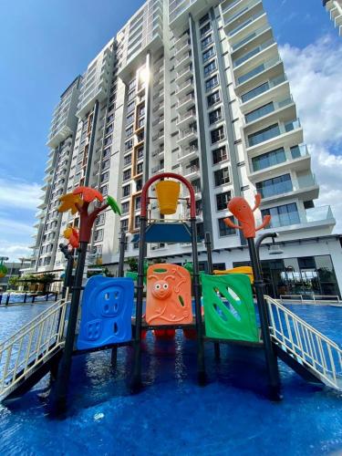 a playground in the water in front of a building at K AVENUE B17 house room near airport by Gc in Kota Kinabalu