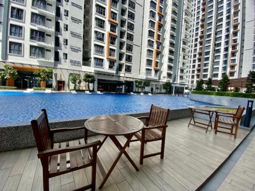 a patio with a table and chairs next to a pool at K AVENUE B17 house room near airport by Gc in Kota Kinabalu