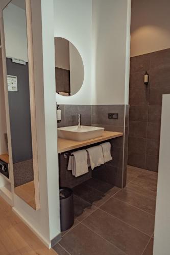 a bathroom with a sink and a mirror at Mariandl am Berg in Amberg