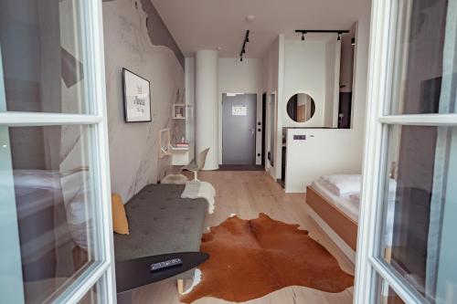 a room with a hallway with a bed and a window at Mariandl am Berg in Amberg