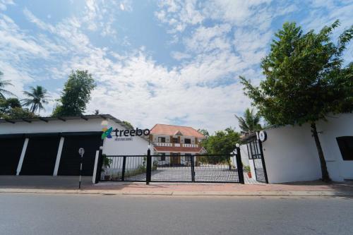 a fence in front of a building with a house at Treebo West Fort Divine - Near Padmanabhaswamy Temple in Trivandrum