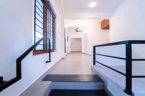 a hallway of a house with stairs and a window at Treebo West Fort Divine - Near Padmanabhaswamy Temple in Trivandrum