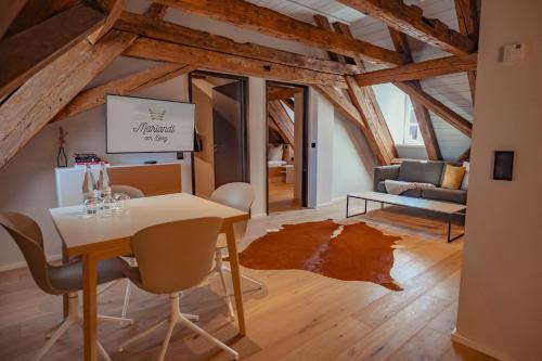 a living room with a table and chairs and a couch at Mariandl am Berg in Amberg