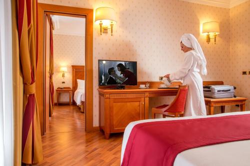 a woman standing in a hotel room at Best Western Hotel Viterbo in Viterbo