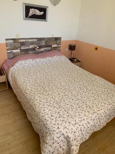 a bedroom with a bed with a comforter on it at Great Choice Apartment in Chernomorets