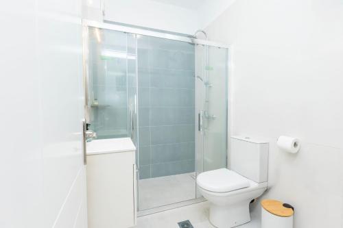 a bathroom with a toilet and a glass shower at Smart Home Corfu 3 in Potamós