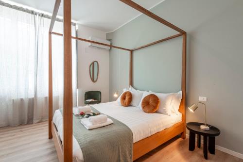 a bedroom with a canopy bed with two pillows at Bazzi, 49 - Bocconi University in Milan