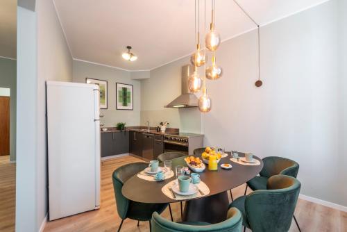 a kitchen and dining room with a table and chairs at Bazzi, 49 - Bocconi University in Milan