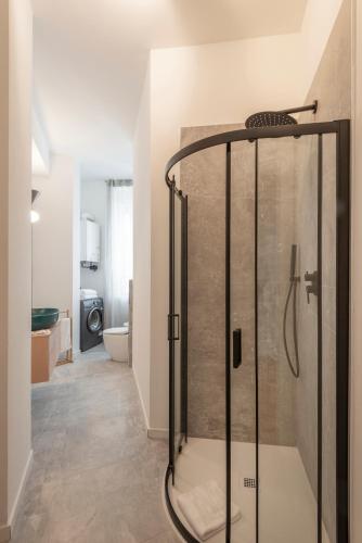 a bathroom with a shower with a glass door at Bazzi, 49 - Bocconi University in Milan