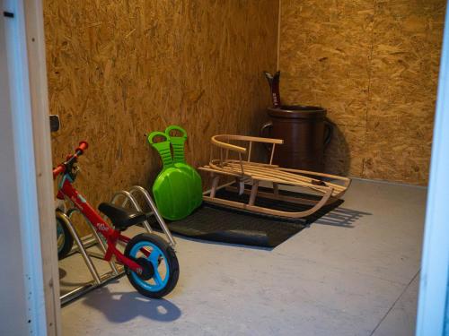 a bike parked next to a chair and a vase at Apartamenty Wisła Krzywa 8, wanna z hydromasażem, basen zewnętrzny in Wisła