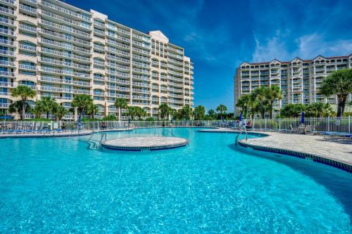 a swimming pool in front of a large building at Sandy Tee Resort Suite w Giant Pool Oasis in Myrtle Beach