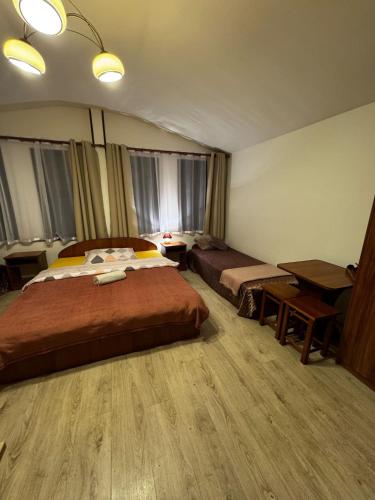a bedroom with a large bed and a desk at ahoj PRZYLESIE in Pobierowo