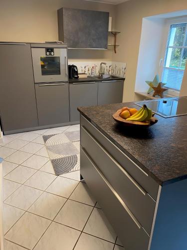 a kitchen with a bowl of fruit on a counter at Ferienhaus auffm Hebberg in Attendorn