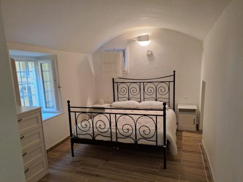 a bedroom with a bed and a dresser and a window at Casa Romeo lago di Como in Abbadia Lariana