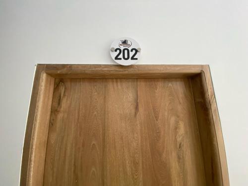 a clock on top of a wooden door at Hotel Panther Resort in Necoclí