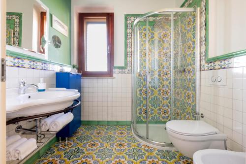 a bathroom with a shower and a toilet and a sink at Residenza Marano in Cupra Marittima