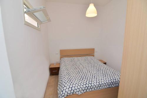 a small bedroom with a bed in a room at Casa Nzinu a soli 170 mt dal mare di Torre Colimena in Torre Colimena
