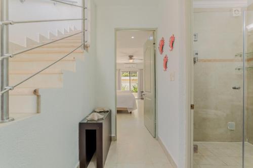 a hallway with a staircase and a glass door at Cancun Hotel Zone -2 BR Beachfront, Bright and Spacious in Cancún
