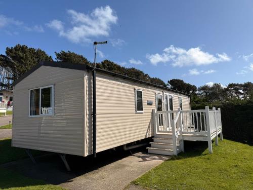 a white tiny house with a porch and a ramp at Willows Way Newquay Holiday Park in Newquay