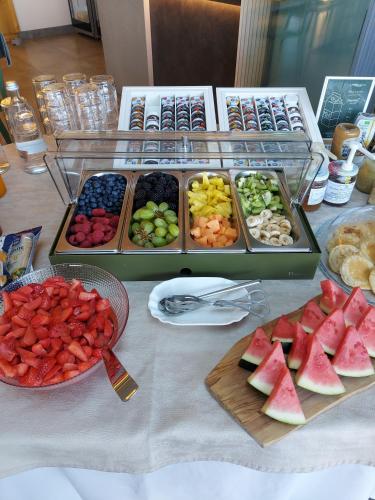 a table with a bunch of different types of fruit at La Cipressina B&B in Cavaion Veronese