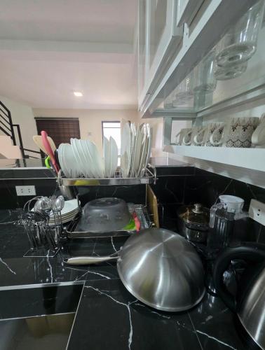 a kitchen with a counter top with plates and utensils at Mamadear's Bed & Breakfast in Suizo