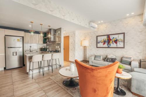 a kitchen and living room with a couch and a table at Breakfast included Regatta living II 404 in Los Prados