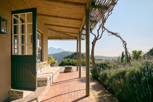 a porch of a house with a green door at 7 Koppies in Franschhoek
