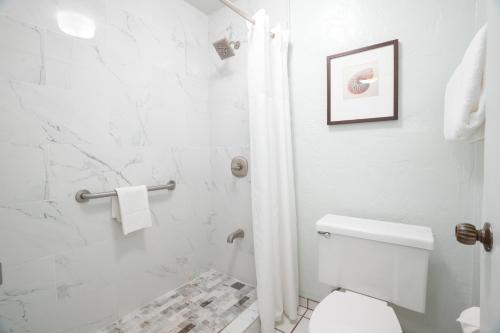a white bathroom with a toilet and a shower at "Island Time" at Plantation Hale D4 in Kapaa